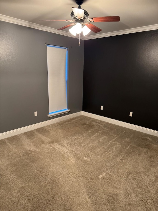 carpeted spare room with ceiling fan and crown molding