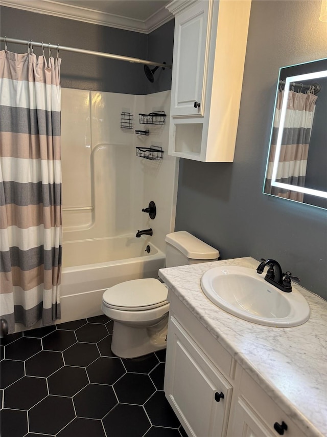 full bathroom featuring tile patterned floors, vanity, shower / bath combo with shower curtain, crown molding, and toilet