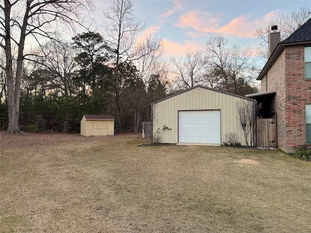 garage at dusk with a yard