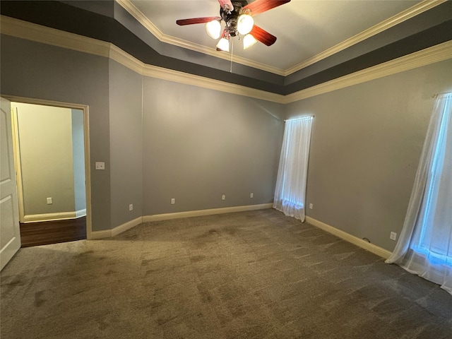 empty room featuring crown molding, ceiling fan, and dark carpet