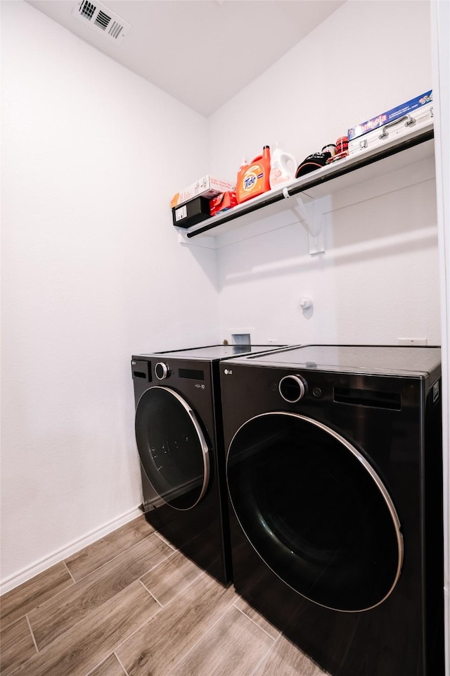 washroom with washing machine and clothes dryer