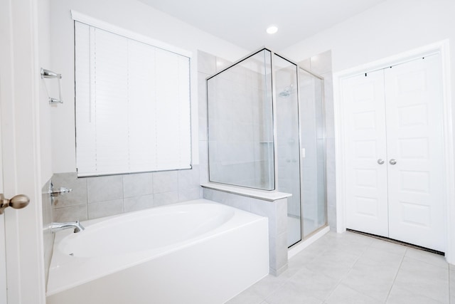 bathroom featuring tile patterned flooring and independent shower and bath