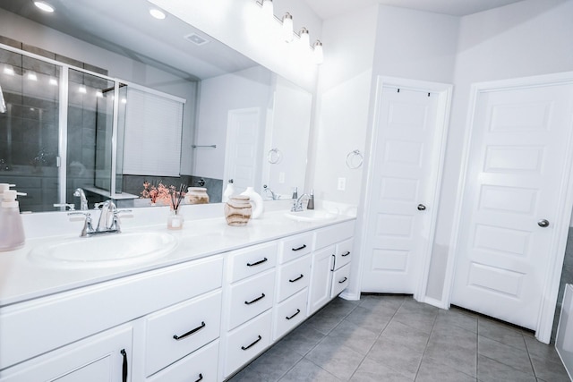 bathroom with vanity, tile patterned floors, and a shower with shower door