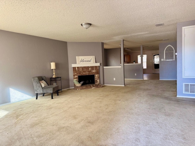 carpeted living room featuring a textured ceiling and a brick fireplace