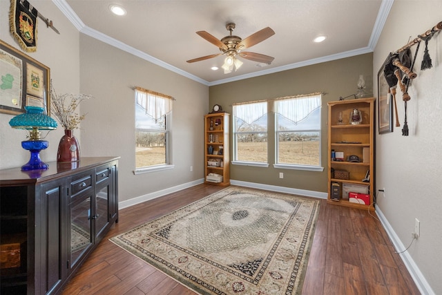 living area with dark hardwood / wood-style floors, plenty of natural light, and crown molding