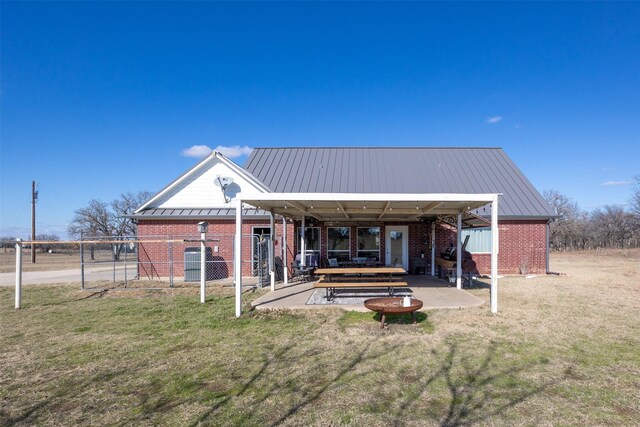 rear view of house featuring a yard and a patio