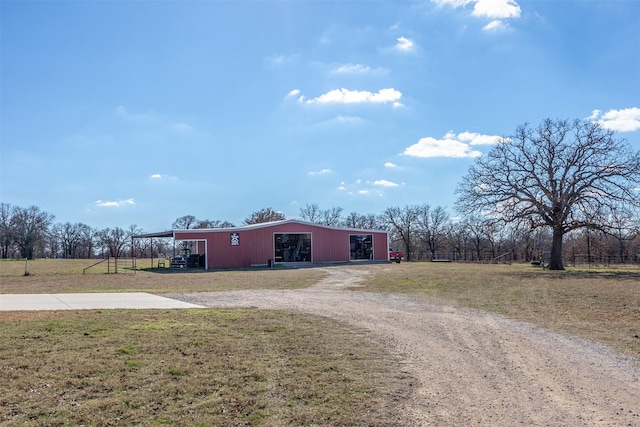 view of front of property featuring an outbuilding and a front lawn