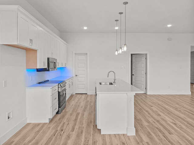 217 Rosemary Dr, Azle, TX 76020 - kitchen featuring stainless steel appliances, a sink, light wood finished floors, baseboards, and light countertops
