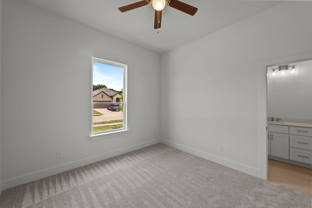 217 Rosemary Dr, Azle, TX 76020 - unfurnished bedroom featuring light carpet, baseboards, a sink, and connected bathroom