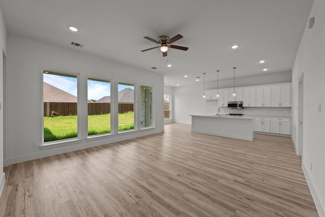 217 Rosemary Dr, Azle, TX 76020 - unfurnished living room featuring baseboards, a sink, light wood-style floors, recessed lighting, and ceiling fan