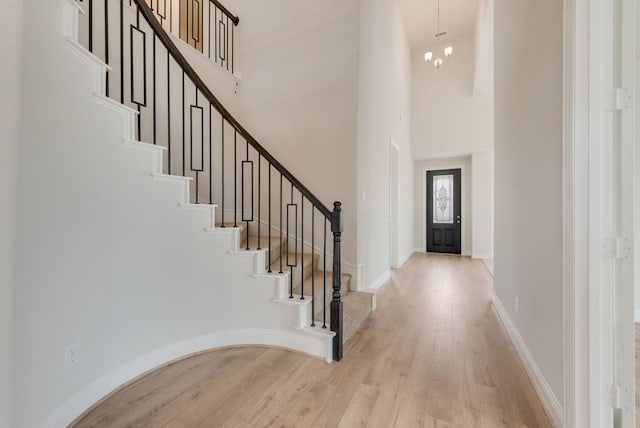1224 Calebria Way, Fate, TX 75087 - foyer entrance with a towering ceiling, light wood-style flooring, stairway, and baseboards