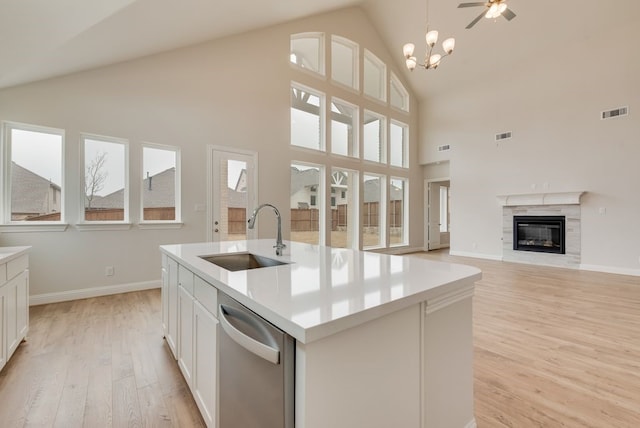 1224 Calebria Way, Fate, TX 75087 - kitchen featuring a sink, stainless steel dishwasher, light wood finished floors, high vaulted ceiling, and healthy amount of natural light