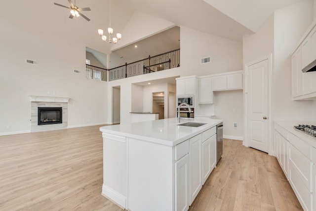1224 Calebria Way, Fate, TX 75087 - kitchen featuring a sink, high vaulted ceiling, stainless steel dishwasher, built in microwave, and light wood finished floors