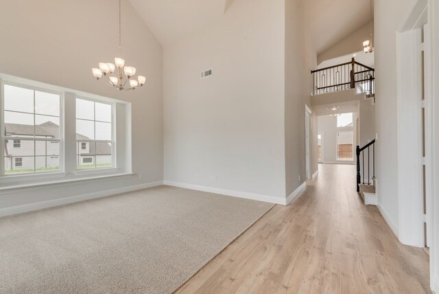 1224 Calebria Way, Fate, TX 75087 - unfurnished dining area featuring a chandelier, high vaulted ceiling, baseboards, light wood-style flooring, and stairway