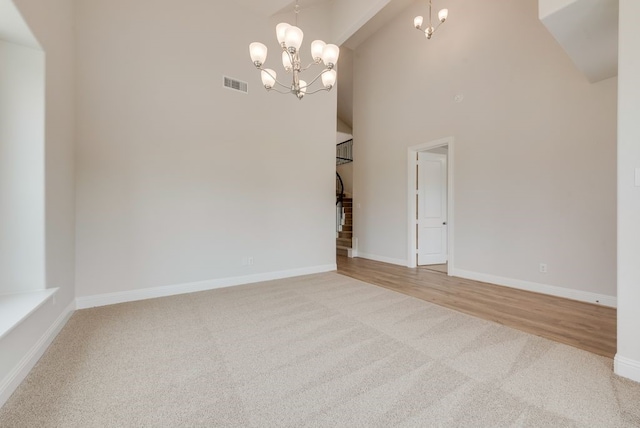 1224 Calebria Way, Fate, TX 75087 - unfurnished dining area featuring carpet floors, a chandelier, a towering ceiling, and baseboards