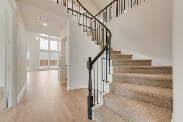 1224 Calebria Way, Fate, TX 75087 - stairway with baseboards, wood finished floors, a high ceiling, recessed lighting, and a chandelier