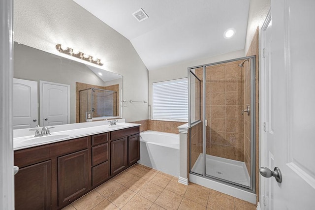 bathroom featuring lofted ceiling, a sink, a shower stall, and tile patterned floors