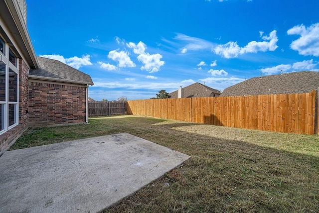 view of yard featuring a patio and a fenced backyard