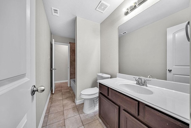 bathroom with toilet, vanity, visible vents, and tile patterned floors