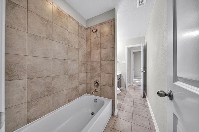 full bath featuring visible vents, baseboards, vanity, tile patterned floors, and washtub / shower combination