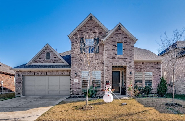 view of property featuring a garage and a front lawn