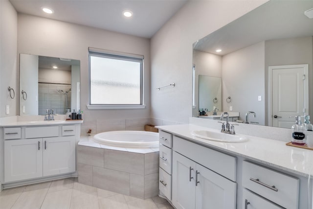 bathroom featuring tile patterned flooring, vanity, and plus walk in shower