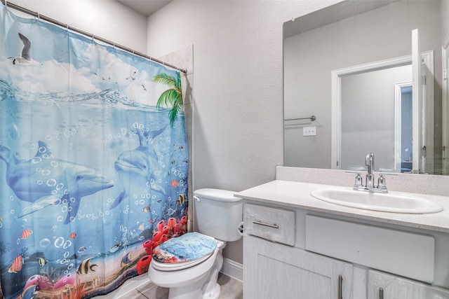 bathroom featuring vanity, toilet, and curtained shower