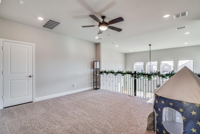 empty room featuring carpet floors and ceiling fan