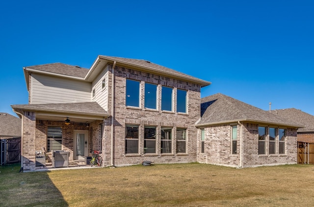 rear view of property featuring a lawn, ceiling fan, an outdoor hangout area, and a patio