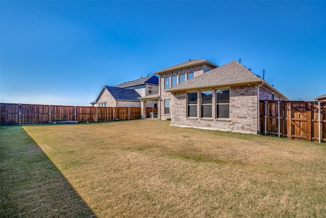 back of house with a lawn