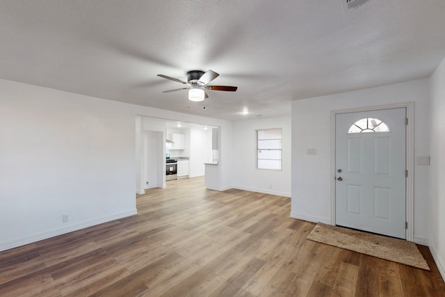 entrance foyer with light wood finished floors, a ceiling fan, and baseboards