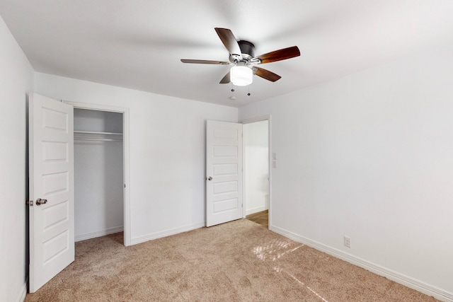 unfurnished bedroom featuring baseboards, a closet, and light colored carpet