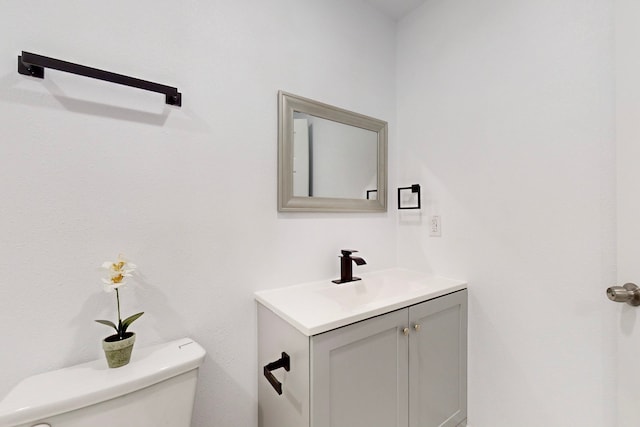 half bathroom featuring toilet and vanity