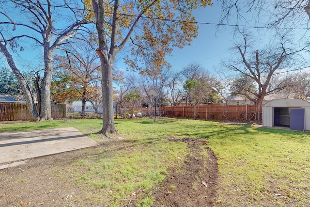 view of yard featuring a storage shed, a patio, an outdoor structure, and a fenced backyard