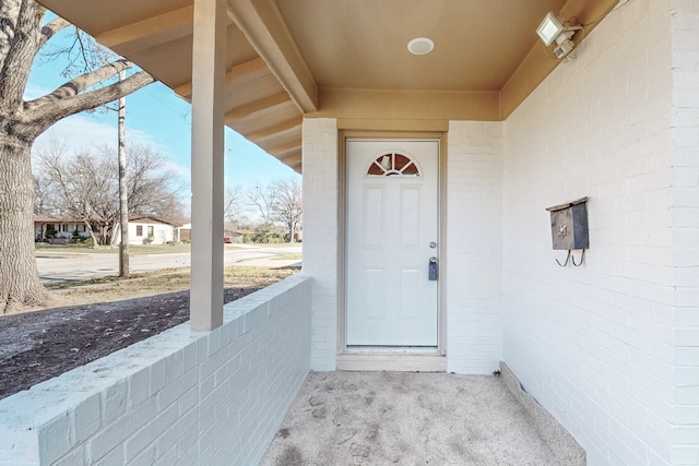 view of exterior entry with brick siding