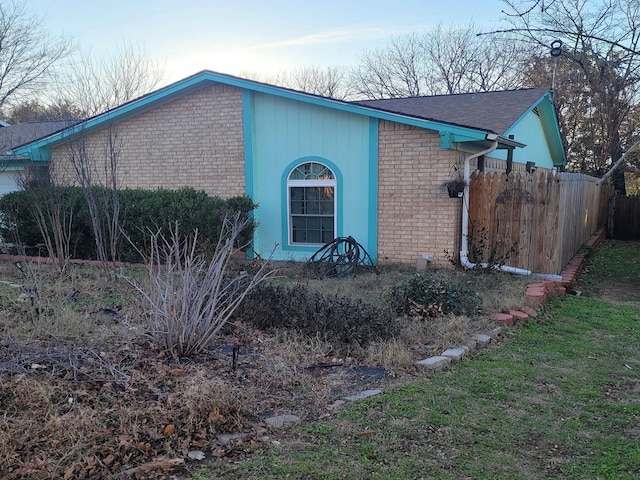 view of front of house with fence and brick siding