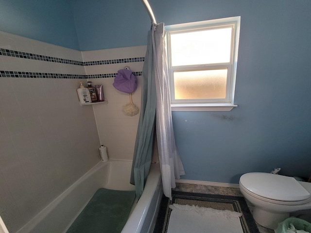 bathroom featuring toilet and shower / tub combo with curtain