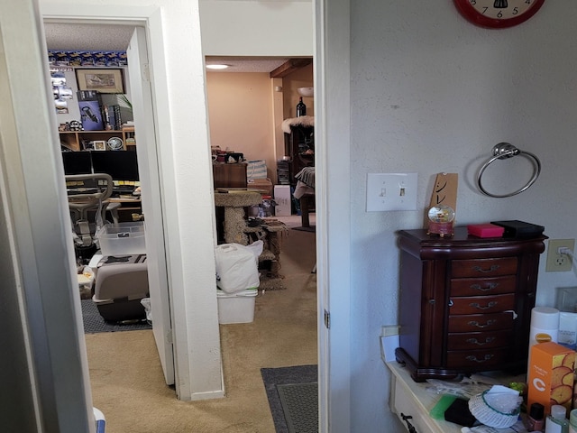 hallway featuring light colored carpet