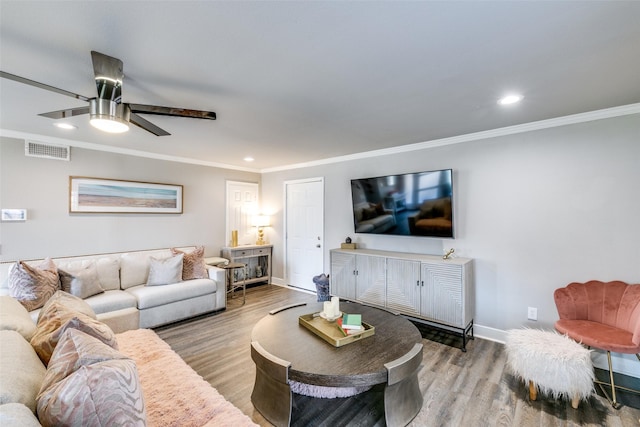 living room with wood-type flooring, ceiling fan, and crown molding