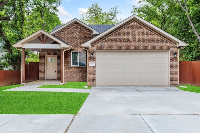 view of front facade featuring a front yard and a garage