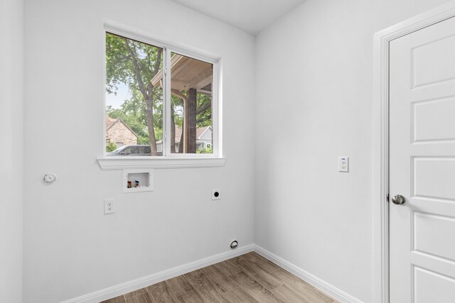 laundry room featuring hookup for a washing machine, electric dryer hookup, and light hardwood / wood-style flooring