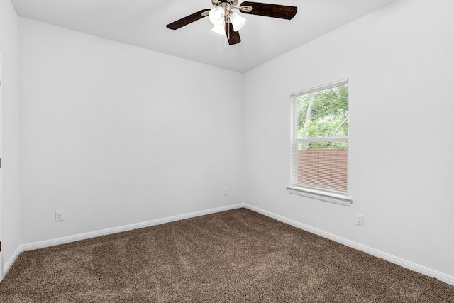 carpeted spare room featuring ceiling fan