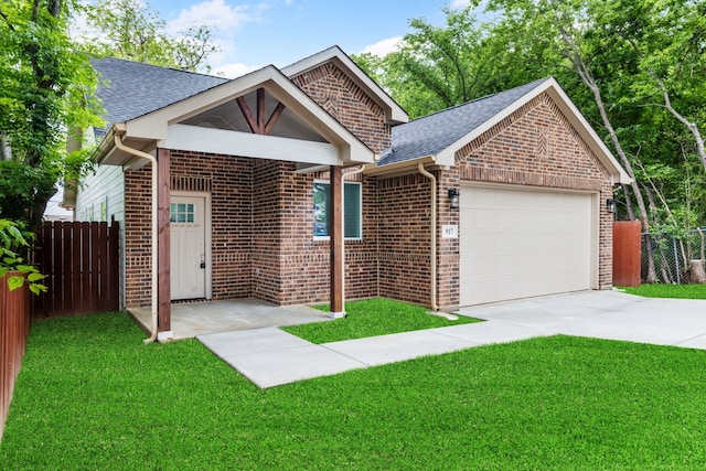 view of front of property with a garage and a front yard