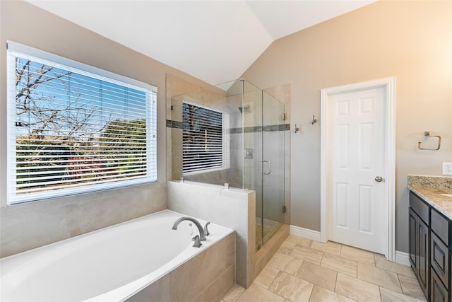 bathroom featuring tile patterned flooring, shower with separate bathtub, vanity, and lofted ceiling