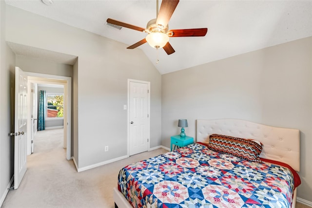 carpeted bedroom with vaulted ceiling and ceiling fan