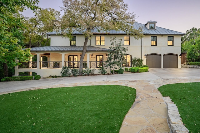 view of front facade with a lawn and a garage