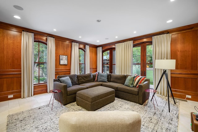 living room with wooden walls and crown molding