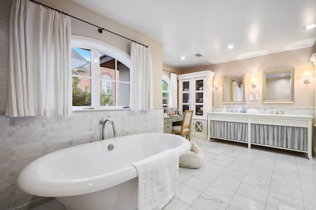 bathroom with vanity and a tub to relax in