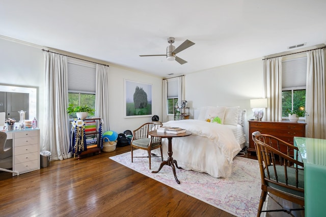 bedroom featuring ceiling fan, dark hardwood / wood-style floors, and crown molding