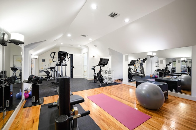 exercise room featuring light wood-type flooring and lofted ceiling